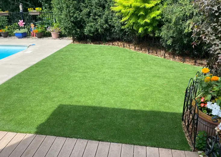 Artificial pet turf installation in a landscaped Milwaukee backyard by Premier Turf & Greens, designed for pets and luxury outdoor living.