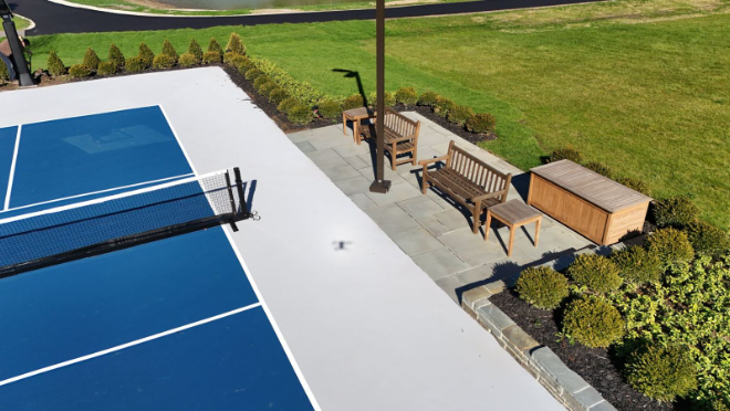 Bluestone patio beside a backyard sport court